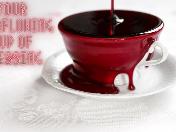 A red cup with the words Your overflowing cup of blessing